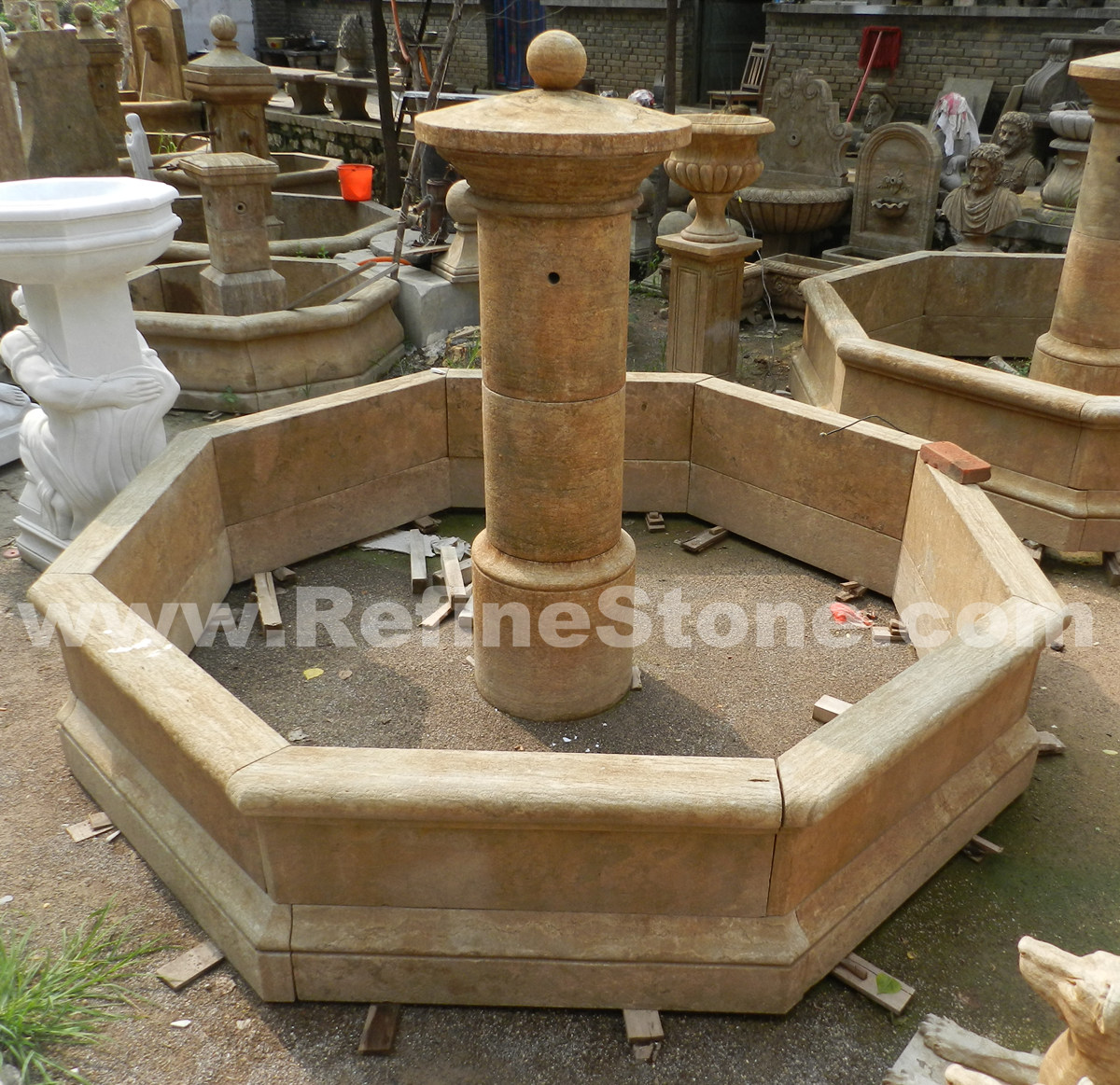 Antique beige limestone water fountain